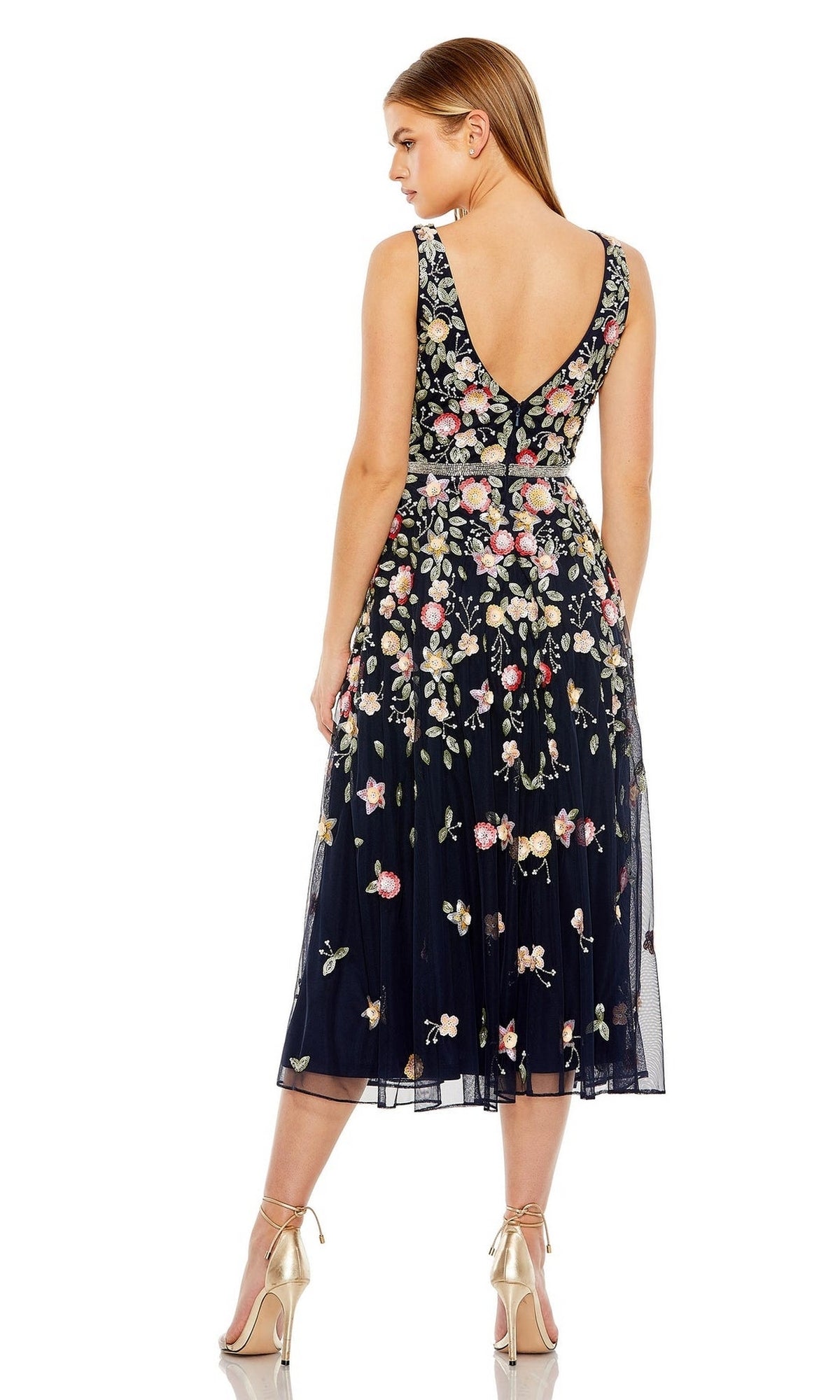 A woman in the Mac Duggal 5527 floral-embroidered party dress.